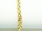 a close up of a gold bracelet on top of a napkin