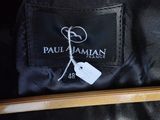 the label of a black jacket with a white tag on it