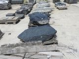 many pieces of concrete sitting on the ground in a parking lot