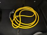 a yellow hose that is connected to a car ' s trunk