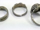 three silver rings sitting next to each other on a white surface