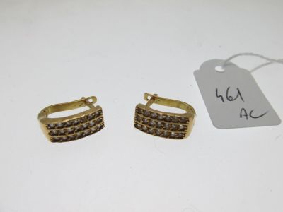 a pair of gold tone earrings with brown crystals