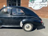 a black car that is parked in front of a building