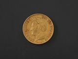 a gold coin on a black surface