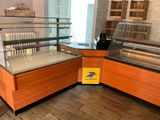 a display case in the middle of a room with wooden flooring