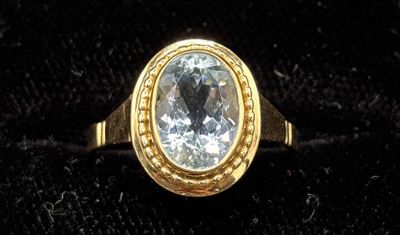 an image of a gold ring with a white diamond in it