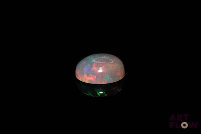 an image of a white fire opal in the dark