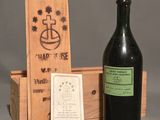 a bottle of wine sitting next to a wooden box