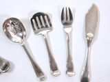 five forks and spoons sitting on a table