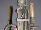 a person that is holding a candle holder in their hand