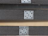 a close up of a pair of metal straps with holes on them