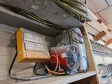 a fan and a heater on a shelf in a room
