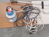 a table with a bunch of wires and a water bottle