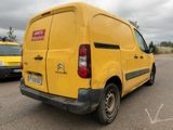 a yellow van that is parked in a parking lot