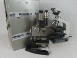 an image of a microscope with a metal case and a box