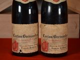 two bottles of wine sitting next to each other on a table