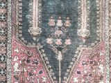 an antique rug with a blue background and a pink border
