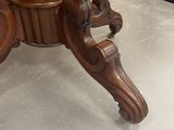 a wooden table with a vase on top of it