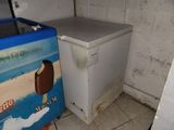 an ice cream machine and a refrigerator in the corner of a room
