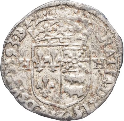 une vieille pièce d'argent sur laquelle figure un blason