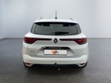 the rear end of a white car in a white room