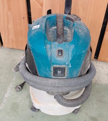 un aspirateur bleu et noir posé par terre