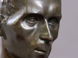 close up of a bronze statue of a man ' s head and shoulders