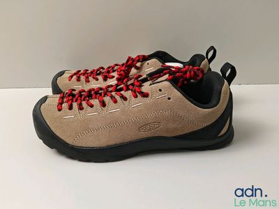 a close up of a pair of hiking shoes with red laces