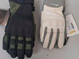 two pairs of gloves sitting on top of a table next to a cell phone