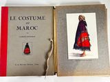 an old book with a picture of a woman in a red dress
