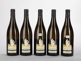 four bottles of wine are lined up on a table