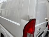 a white van that is parked on the side of the street