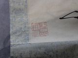 a bird that is sitting on a piece of paper
