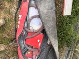 a red duffel bag filled with items sitting on the ground
