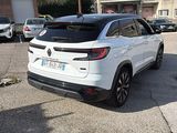 the rear end of a white suv parked in a parking lot