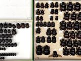 many different types of black buttons in a display case