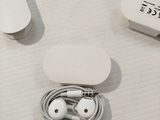 a box of earphones and a pair of headphones on a table