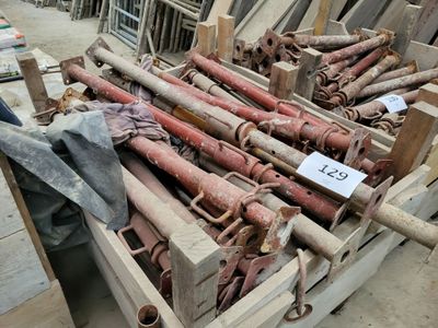 a pile of old rusty pipes in a wooden crate