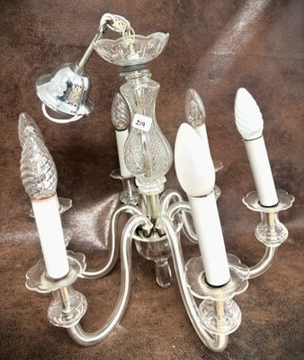 a chandelier that has five lights on it