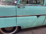 a blue car that is parked on the side of the street