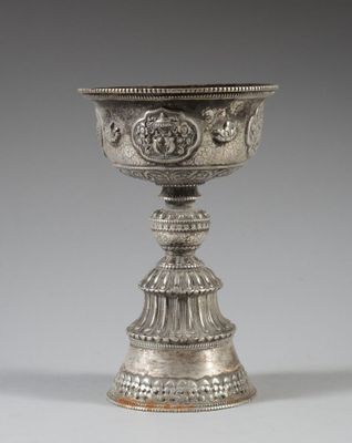 une coupe ancienne en argent ornée d'un motif sur le dessus