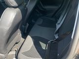 the interior of a small car with the front seats folded down