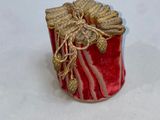 a small red box with a gold decoration on it