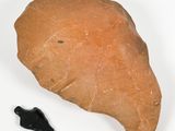 a rock and a black object on a white surface