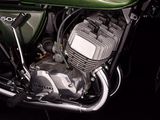 a green kawasaki motorcycle parked in a dark room