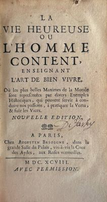 an old book with writing on it sitting on top of a table