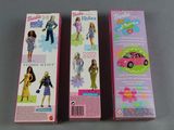 two boxes of barbie dolls sitting next to each other on a table