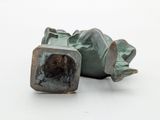 a bronze sculpture of a person laying on the ground
