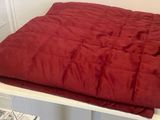 une couverture rouge posée sur une table blanche