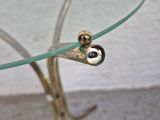 a glass table with a metal base and a glass top